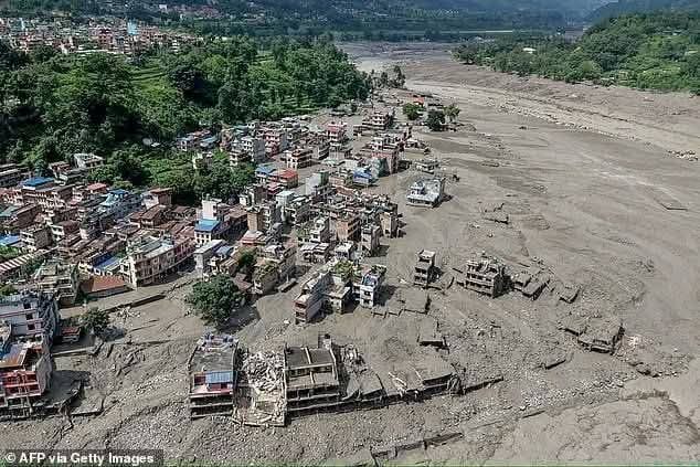 Aerial view of a settlement with buildings destroyed along the river's new course