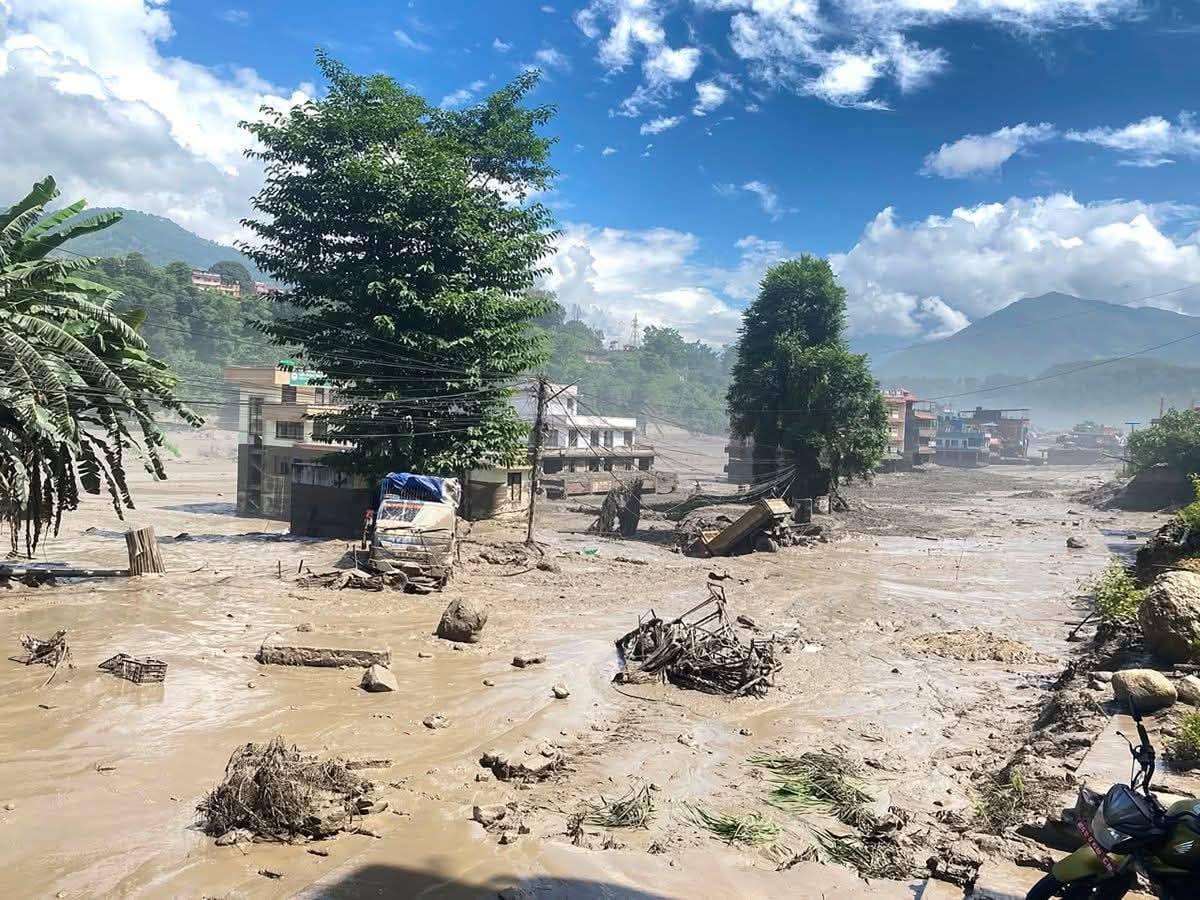 A village street filled with mud, silt and wreckage after the floodwater passed